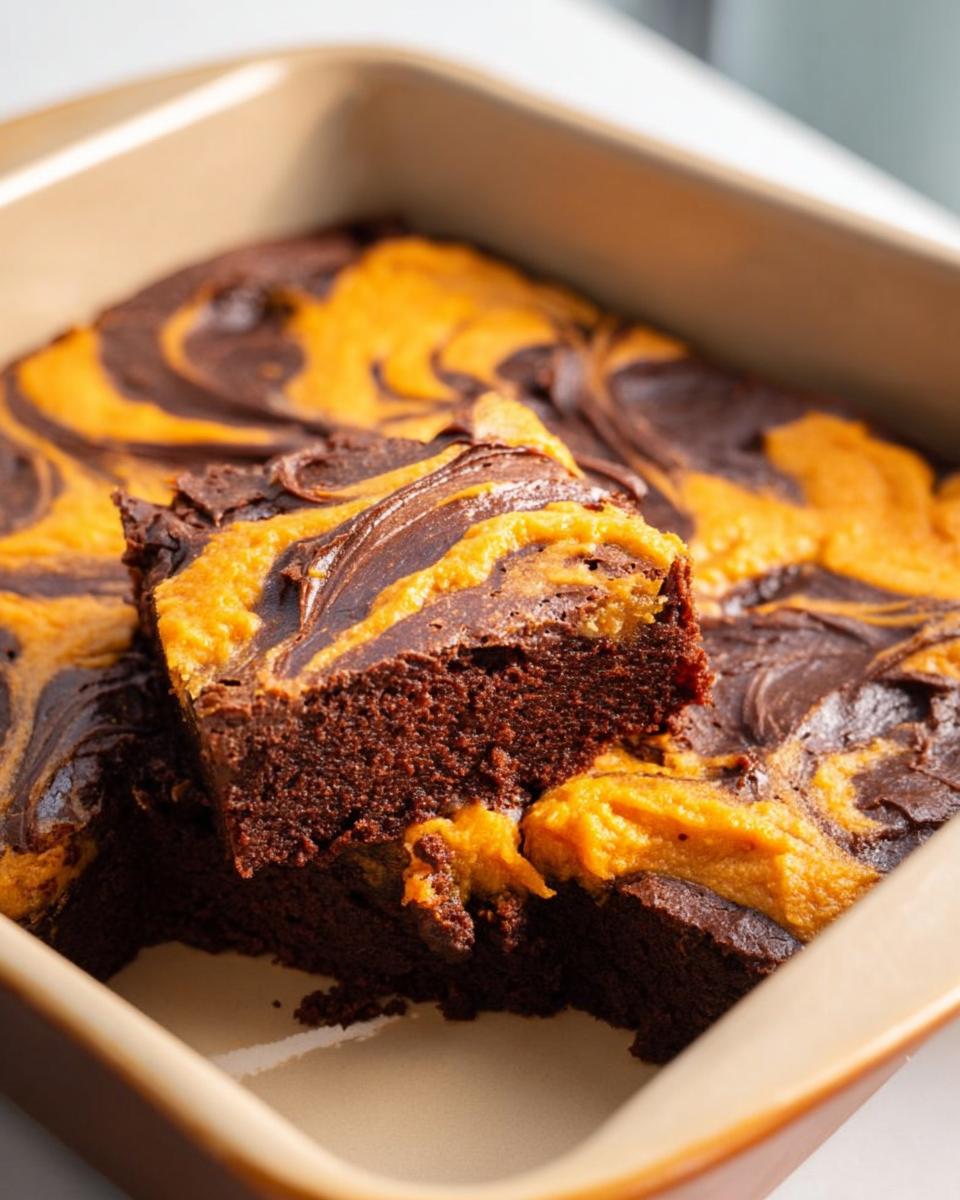 Close-up of a rich chocolate brownie with swirls of pumpkin filling, a perfect Thanksgiving dessert.