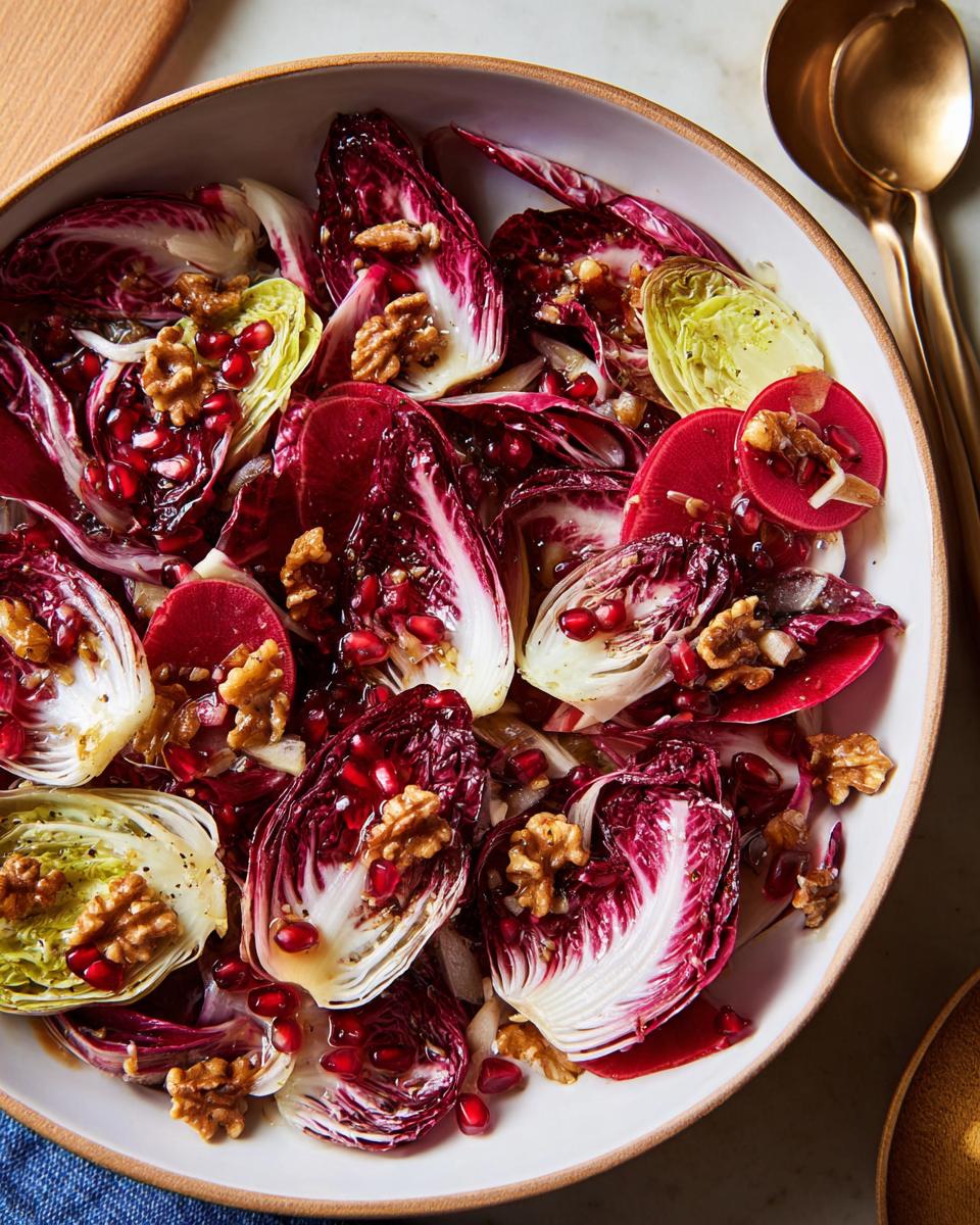 A colorful Thanksgiving salad recipe featuring radicchio, pomegranate seeds, walnuts, and thinly sliced red apples.
