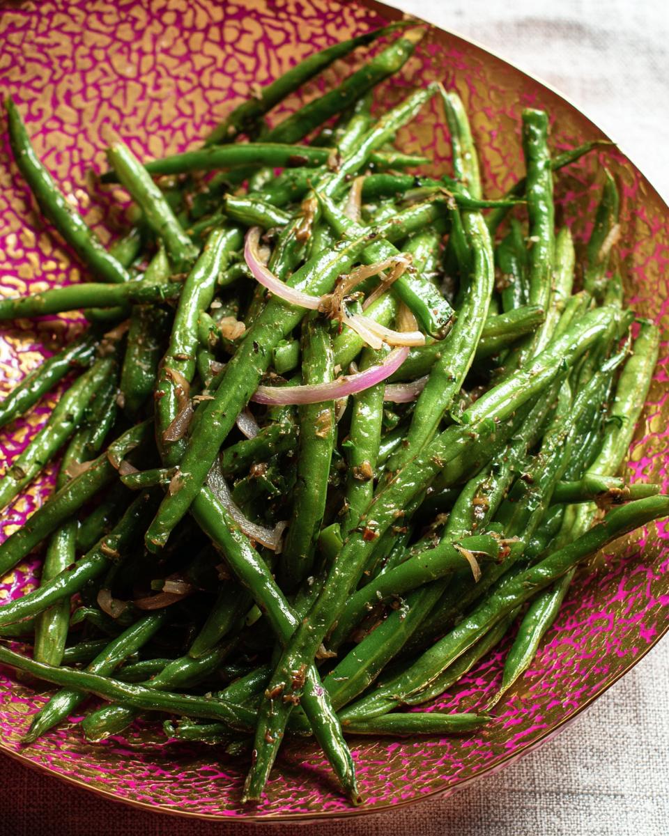 A close-up of a vibrant green bean dish, part of the Best Thanksgiving Veggie Tray 2025, served in a decorative bowl.