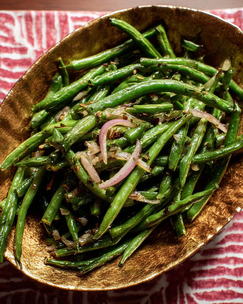 Close-up of a golden bowl filled with fresh green beans and sliced red onions, part of the Best Thanksgiving Veggie Tray 2025.