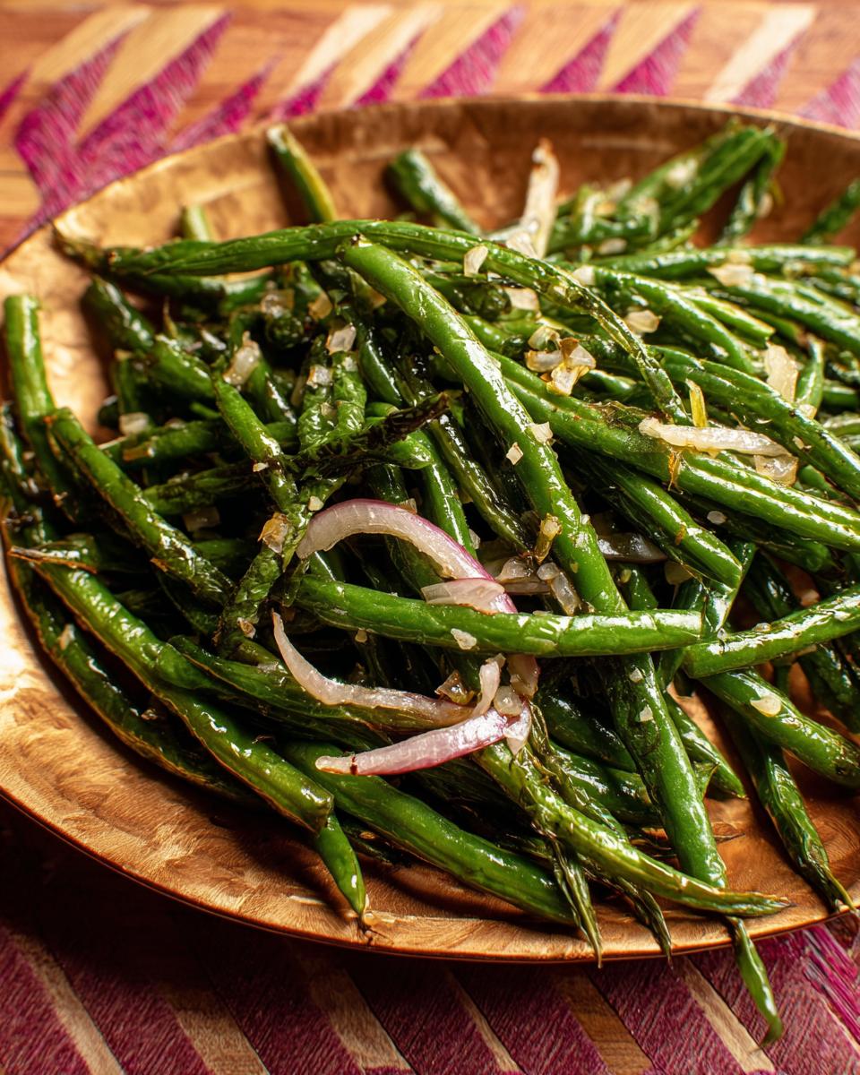 Close-up of roasted green beans with shallots and red onion, part of a Best Thanksgiving Veggie Tray.