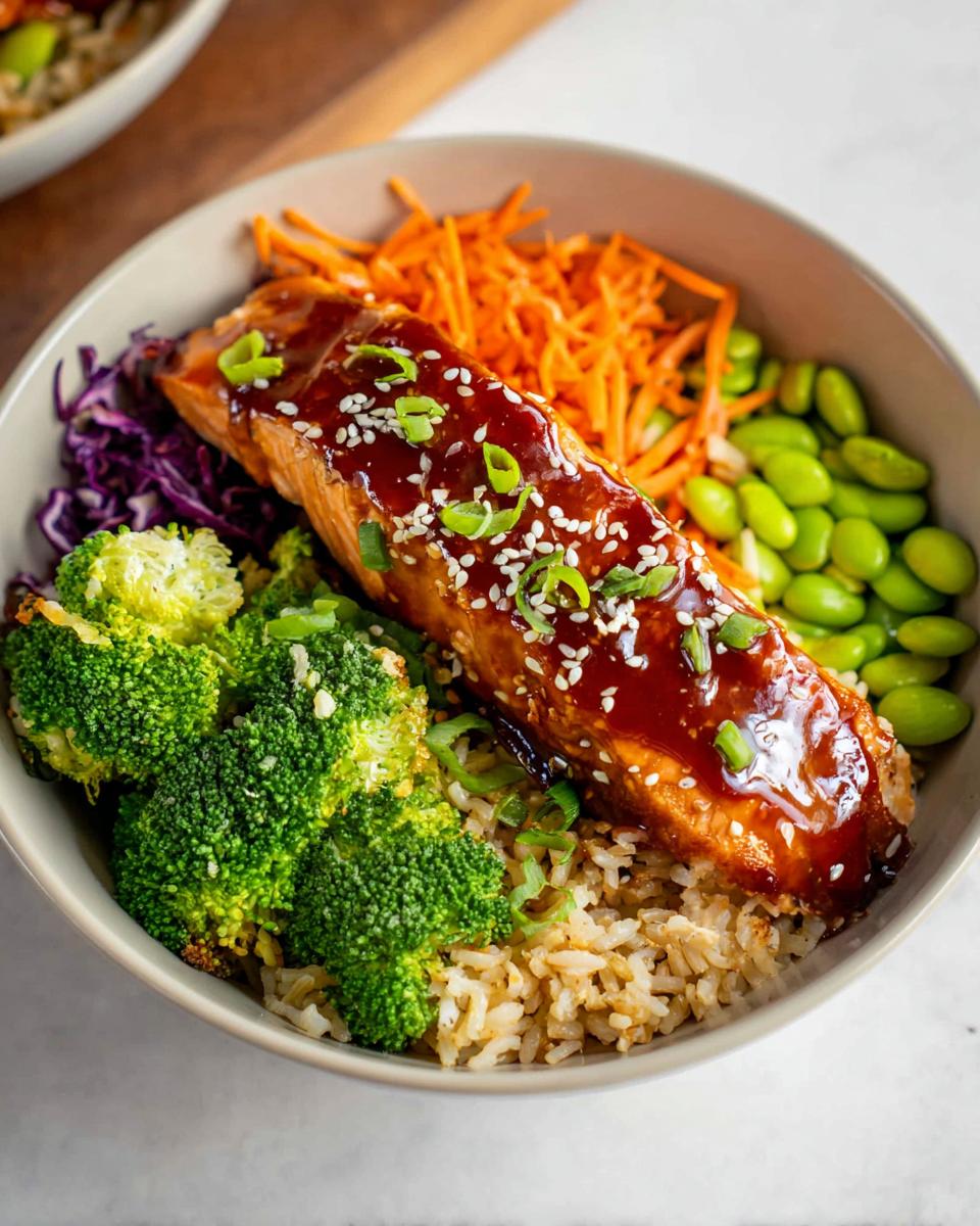 Close-up of a Healthy Teriyaki Salmon and Broccoli Bowls featuring glazed salmon over brown rice and vegetables.