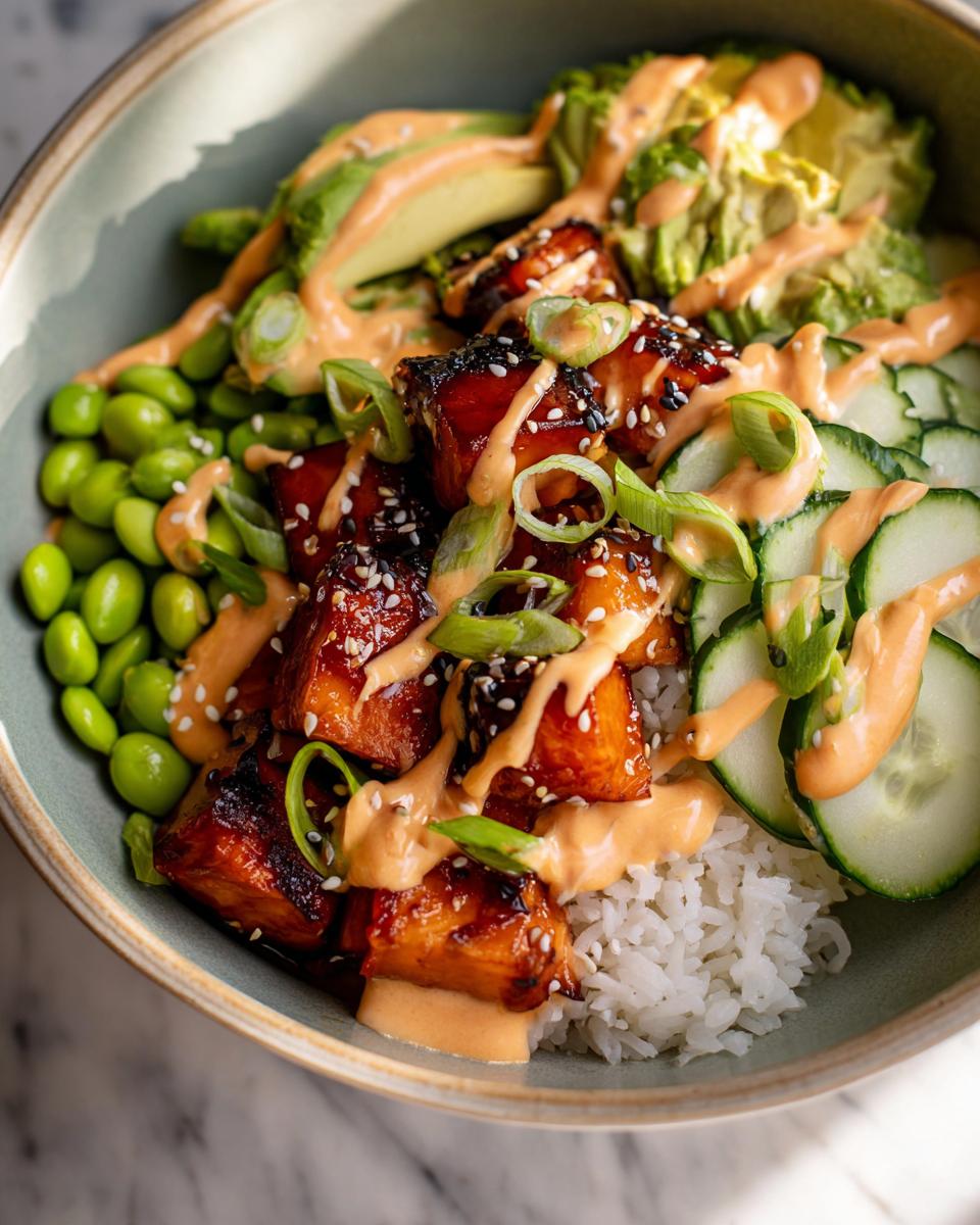 Close-up of Teriyaki Glazed Salmon Rice Bowls with avocado, edamame, cucumber, and spicy mayo.