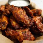 A basket of crispy, seasoned chicken wings, perfect for a quick 20 minute chicken wings recipe.