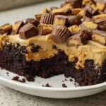 A rich chocolate cake topped with peanut butter frosting and chopped peanut butter cups, part of Cake Ideas Recipes in 12 Minutes.