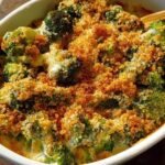 A close-up of a creamy broccoli casserole with a golden breadcrumb topping, perfect for veggie sides.