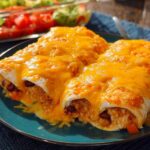 Close-up of cheesy enchiladas filled with rice and beans, part of easy dinner recipes.