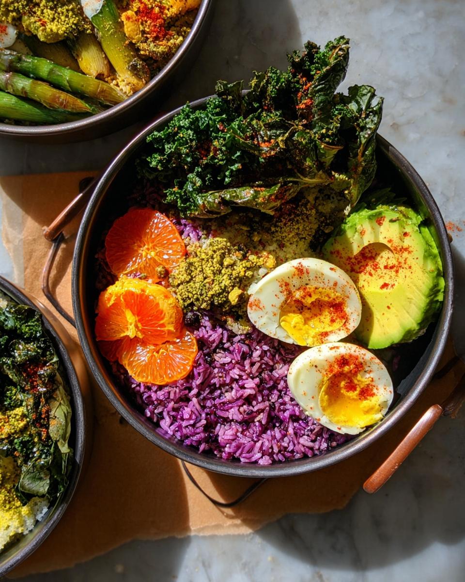 A vibrant bowl featuring purple rice, sliced hard-boiled eggs, avocado, orange segments, and kale, part of the Ultimate Egg Recipes Guide for Beginners.