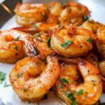 Close-up of perfectly cooked garlic butter shrimp, seasoned and garnished with parsley, from The Ultimate Shrimp Recipes Guide for Beginners.