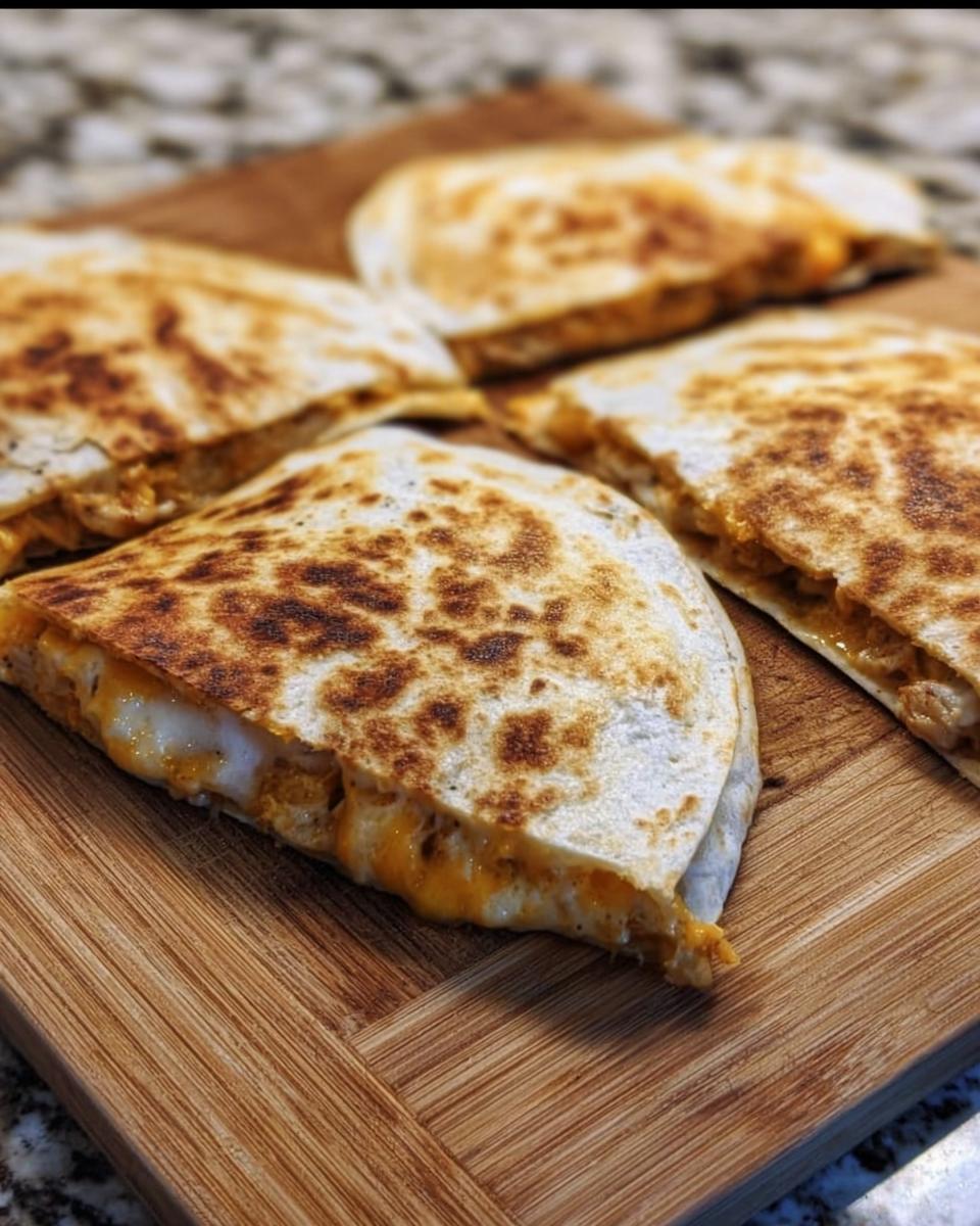 Golden brown slices of High-Protein Chicken Ranch Quesadilla filled with melted cheese and chicken.