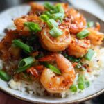 Close-up of Irresistible Honey Garlic Shrimp Bowls with rice and chopped green onions.