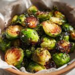 Close-up of perfectly roasted air fryer brussels sprouts, showing crisp edges and caramelized bits.