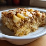 A close-up of a delicious slice of apple cinnamon baked oatmeal with a drizzle of glaze.