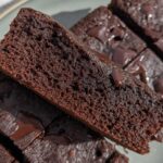 Close-up of moist Greek Yogurt Brownies with visible chocolate chips, showcasing a rich chocolate texture.
