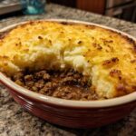 A close-up of a rich and hearty shepherds pie made with ground beef and mashed potato topping.