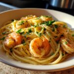 A close-up of a bowl of Lemon Shrimp Linguine pasta, featuring plump shrimp and fresh parsley.