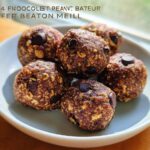 A bowl of No-Bake Chocolate Peanut Butter Protein Balls with visible chocolate chips and oats.