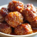 Close-up of delicious slow cooker honey garlic meatballs coated in a glossy sauce, ready for a party.